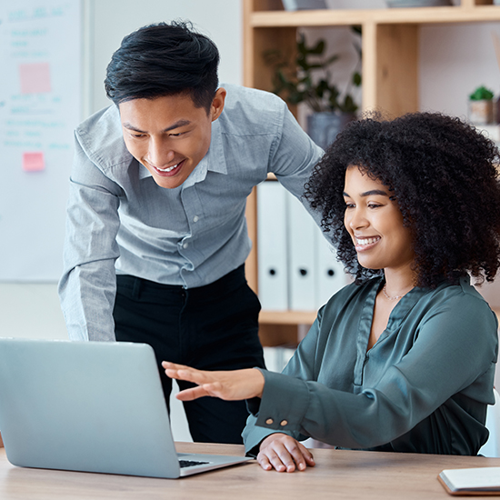 African American woman and Asian employers reviewing One Call data from a laptop.
